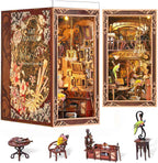 Minicity Painter's Day at Dusk book nook showing Art Nouveau floral panels, miniature furniture, chandelier, artwork and decorative studio details