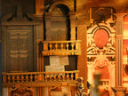Close-up of the Minicity Phantom of the Opera book nook showing miniature wooden balconies, ornate railings, theatre doors and decorative wall panels