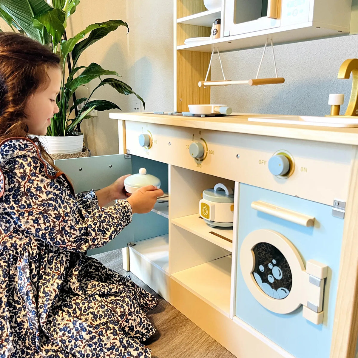 ROBUD Dream Wooden Play Kitchen being used by a child for imaginative cooking and pretend household play