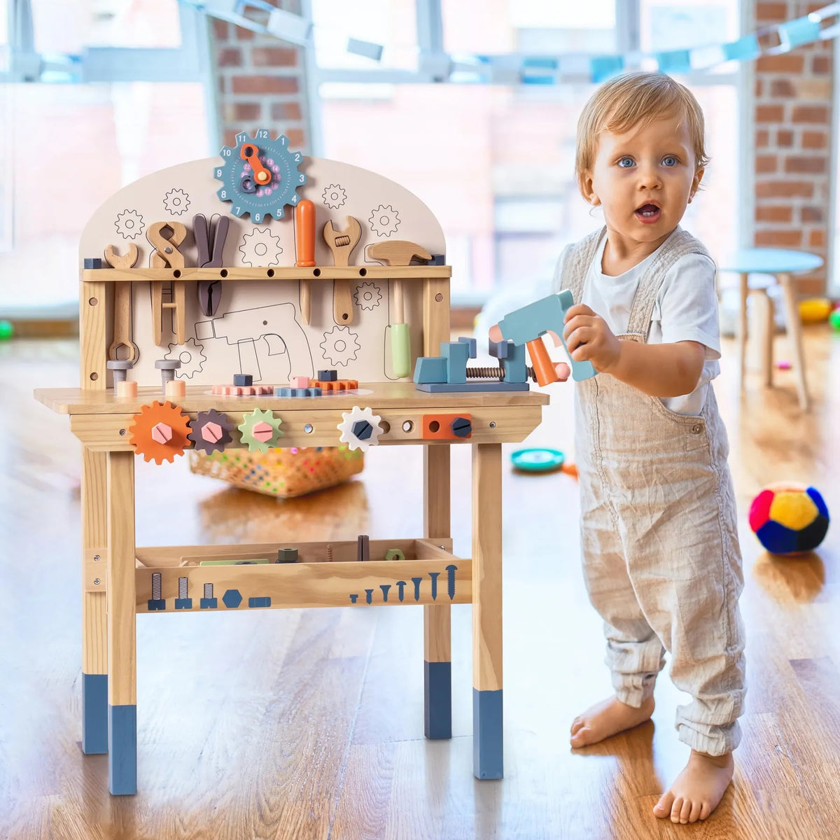 ROBUD Kids Toy Workbench with a child using the wooden tools, bench vise and hands-on construction play features