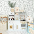 ROBUD modern kids play kitchen displayed in a bright children's playroom with realistic kitchen appliances and accessories