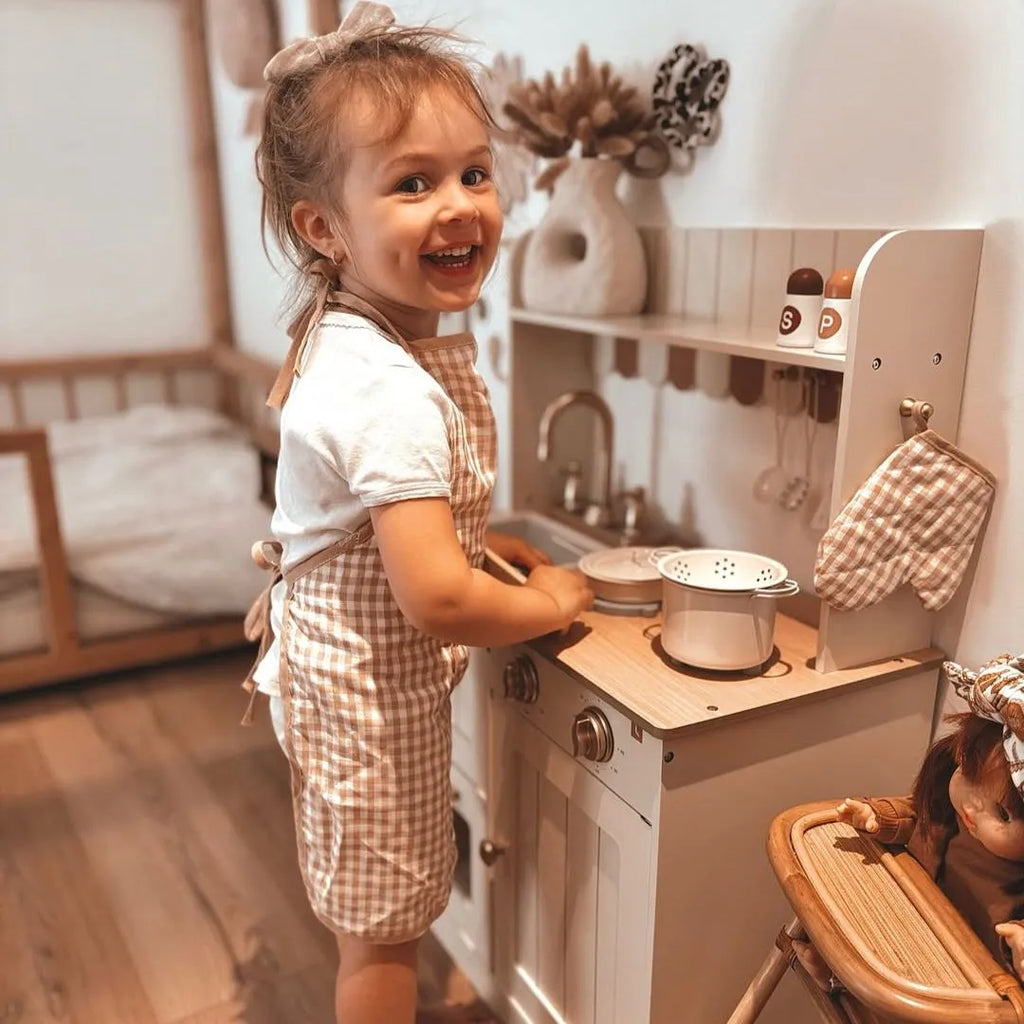 ROBUD Olivia Caramel Wooden Kids Play Kitchen being used by a child for imaginative cooking and pretend play