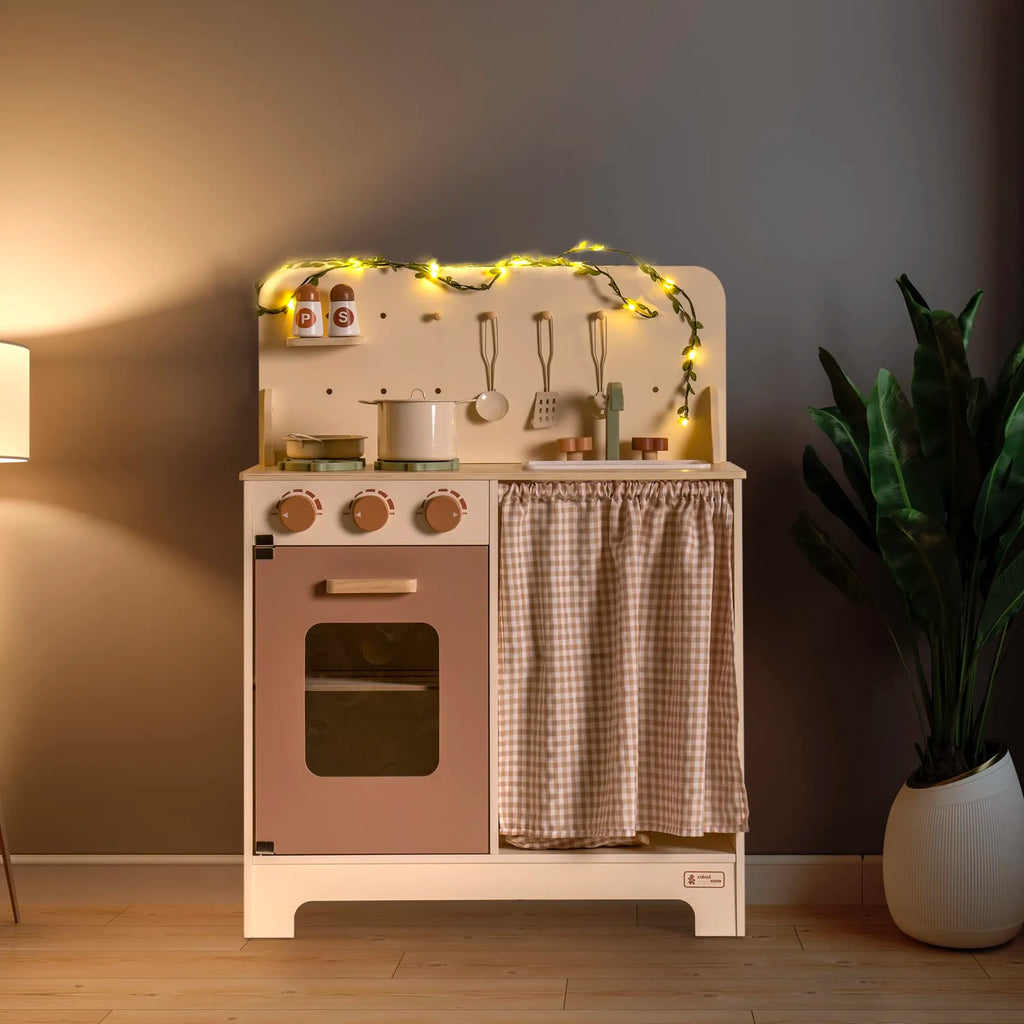 ROBUD Rustic Wooden Kids Play Kitchen with illuminated leaf light string creating a warm pretend play space