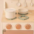 ROBUD Rustic Wooden Kids Play Kitchen close-up showing three rotating stovetop knobs, cookware and wooden cooking accessories
