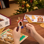 ROKR Angel's Christmas Pyramid DIY assembly showing hands fitting decorative wooden components with illustrated instructions and kit parts on a table