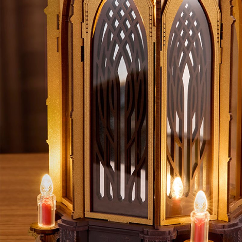ROKR Angel's Christmas Pyramid close-up showing glowing electronic candle lights, decorative wooden supports and warm illumination