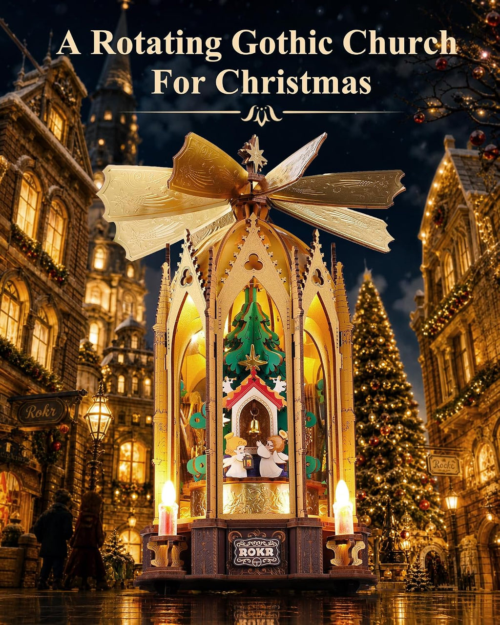 ROKR Angel's Christmas Pyramid illuminated against a festive winter village backdrop, showcasing Gothic cathedral arches, golden rotating blades and a miniature Christmas tree