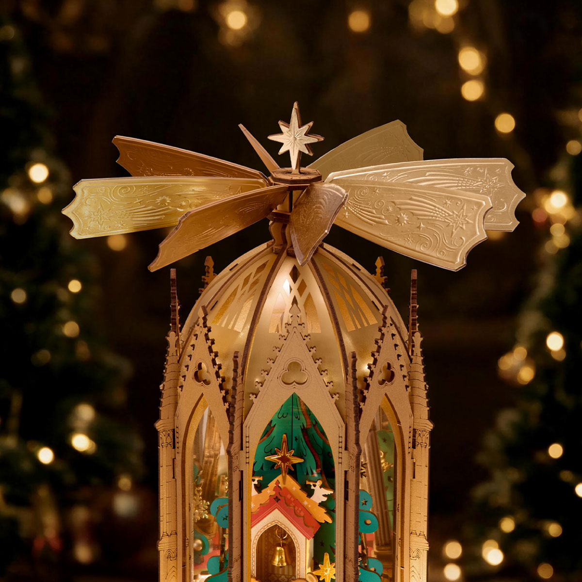 ROKR Angel's Christmas Pyramid close-up highlighting the decorative golden rotating fan blades, star topper and illuminated Gothic roof