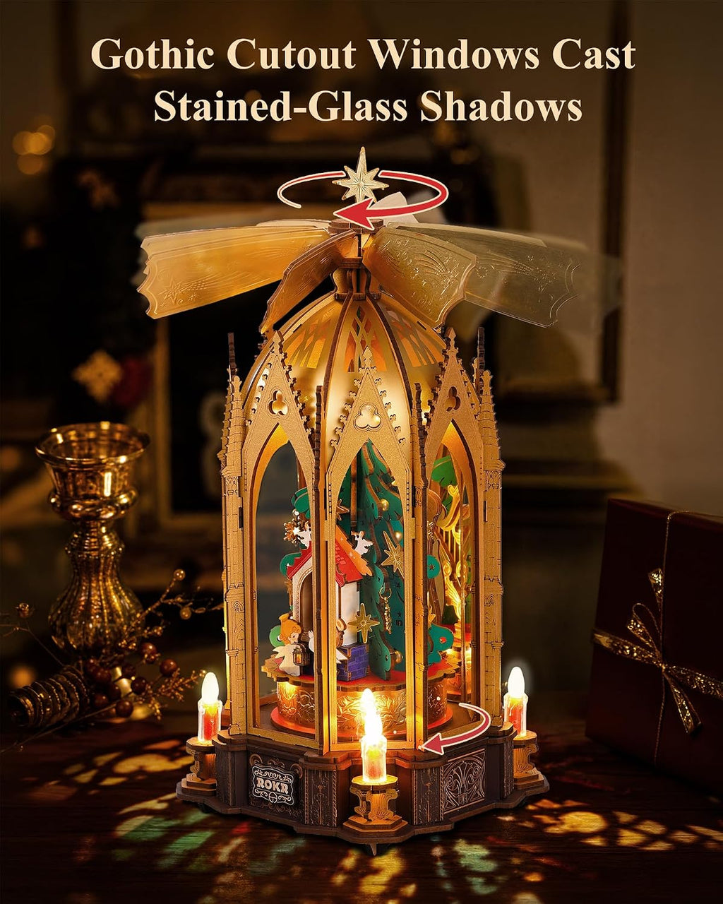 ROKR Angel's Christmas Pyramid demonstrating its rotating inner Christmas scene and spinning upper fan mechanism beneath the Gothic arches