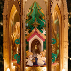 ROKR Angel's Christmas Pyramid interior featuring a green Christmas tree, golden star ornaments, miniature angels and a small Christmas chapel with a brass bell