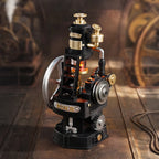 ROKR Thermo Engine miniature mechanical model displayed on an industrial-style surface with a black metal-look body, gold details and illuminated cylinder