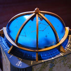 Rolife Astral Dome close-up showing the blue observatory-style dome with a gold frame, constellation patterns, zodiac symbols and celestial markings