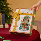 Rolife Caroling Cathedral DIY book nook gift box wrapped with a gold ribbon and bow, featuring the finished illuminated Christmas cathedral design