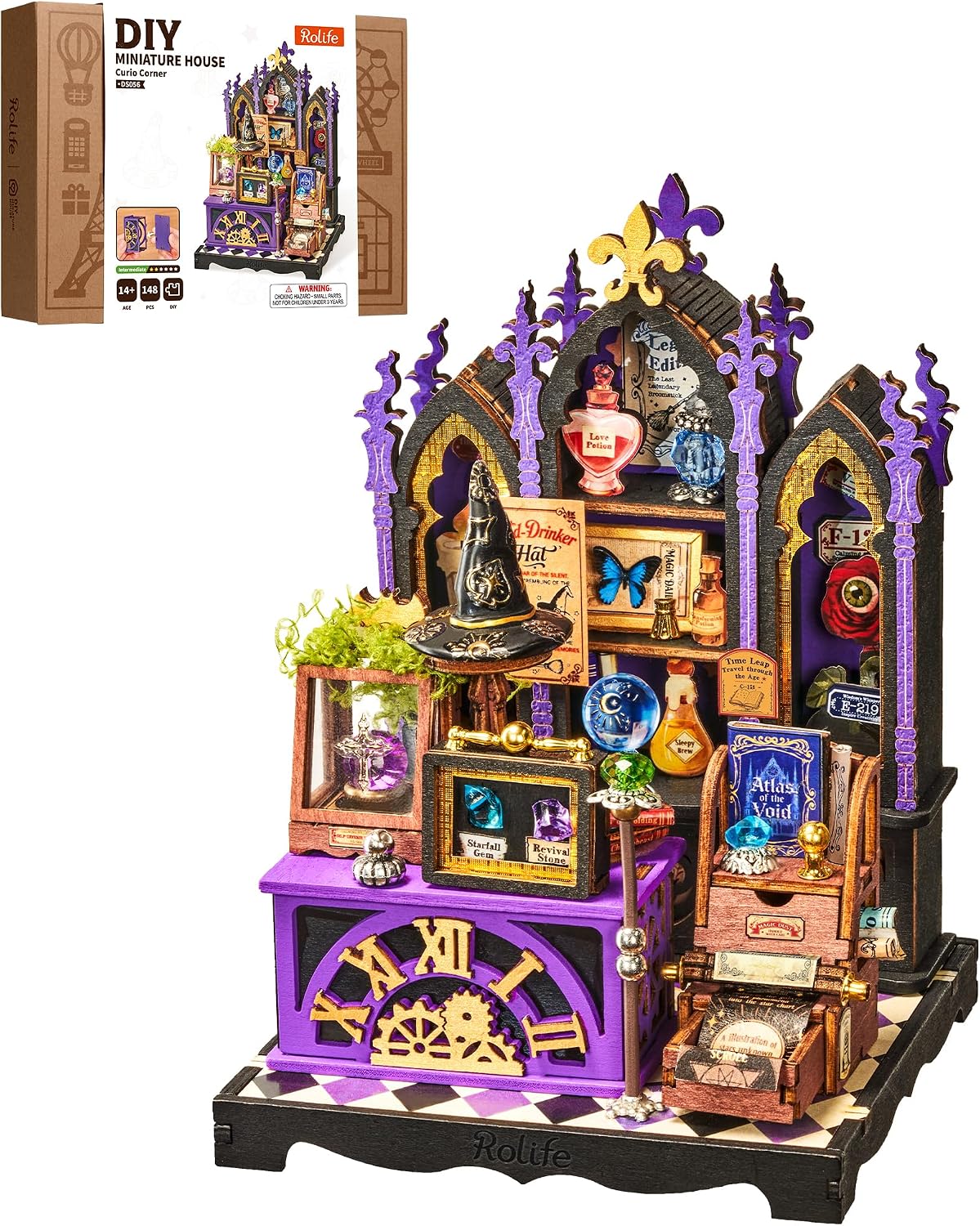 Rolife Curio Corner DS056 miniature house kit with the illustrated product box and completed purple cabinet featuring a wizard hat, potion bottles, crystal balls and magical books