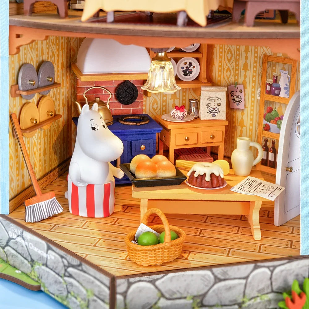 Rolife Moominhouse miniature kitchen featuring Moominmamma preparing food, a blue stove, bread, a baking table and detailed kitchen accessories