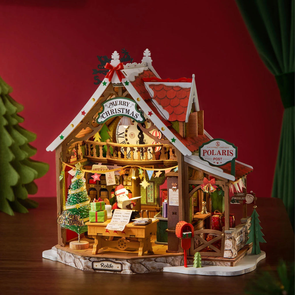 Completed Rolife Polaris Post miniature Christmas house with a glowing interior, red roof, Santa figure, Christmas tree and festive post office details