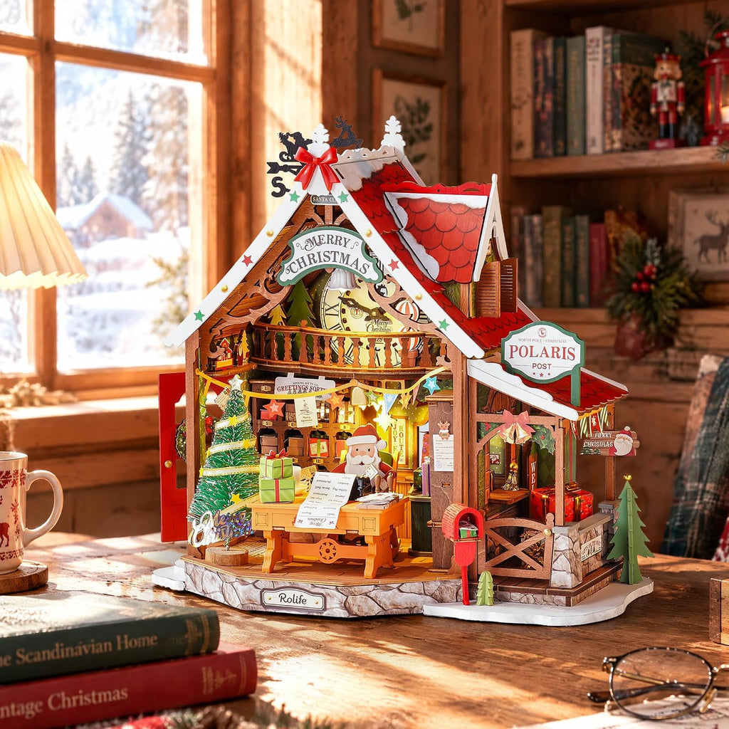 Rolife Polaris Post miniature Christmas post office showing its 24.5 x 16.5 x 23 cm assembled dimensions against a snowy Christmas village background
