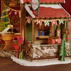 Rolife Polaris Post close-up featuring a miniature Santa figure at his desk with Christmas letters, gift lists, wrapped presents and festive bunting