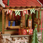Rolife Polaris Post miniature gift display featuring colourful wrapped presents, festive bunting, a wooden parcel window and Christmas decorations