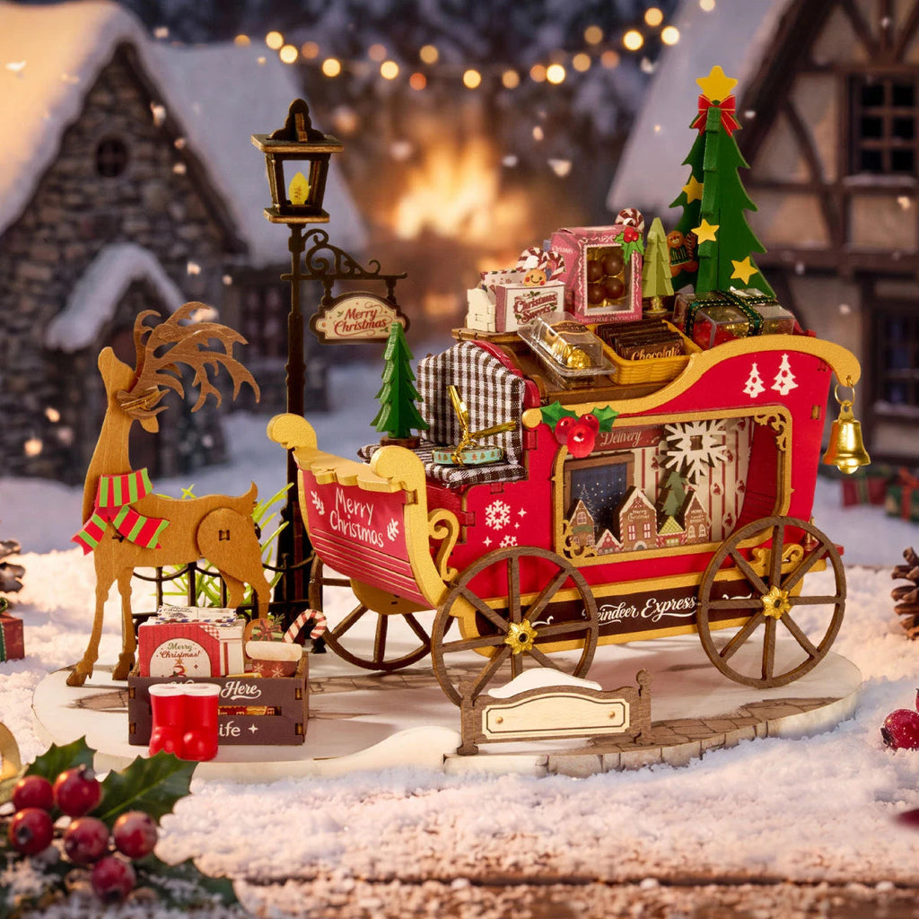 Rolife Reindeer Express wooden reindeer and red Christmas sleigh displayed on a snowy base with miniature gifts, Christmas trees and a festive lamp post