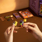 Building the Rolife Whisper Magic Shop miniature book nook with small decorative parts, plants, watering can and wooden base