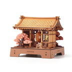 Rowood Sacred Sakura Temple 3D Wooden Puzzle Kit featuring a traditional Japanese shrine gate, curved wooden roof, pink cherry blossom trees and miniature cat characters