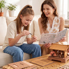 Mother and daughter assembling the Rowood Sacred Sakura Temple 3D Wooden Puzzle Kit using illustrated instructions and pre-cut wooden pieces