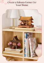 Rowood Sacred Sakura Temple wooden puzzle displayed on a bookshelf and beside books as a Japanese-inspired home decoration