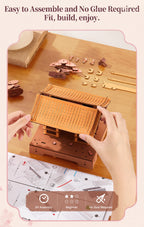 Hands assembling the curved wooden roof of the Rowood Sacred Sakura Temple puzzle with illustrated instructions and loose wooden components on a table