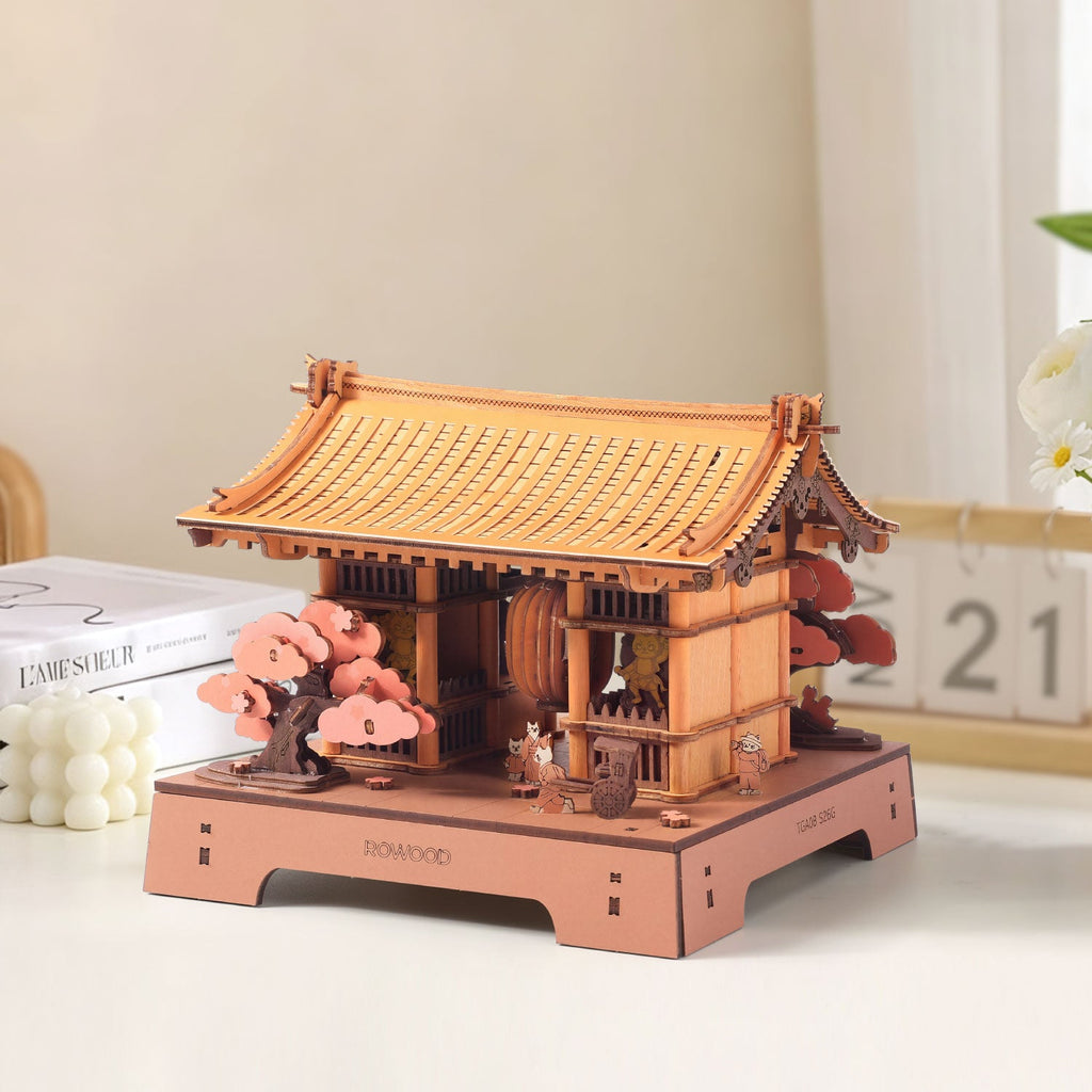 Three-quarter view of the Rowood Sacred Sakura Temple model showing its layered wooden roof, side structure, pink sakura trees and miniature figures