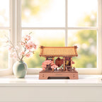 Rowood Sacred Sakura Temple wooden puzzle displayed on a bright windowsill beside a vase of pink cherry blossoms